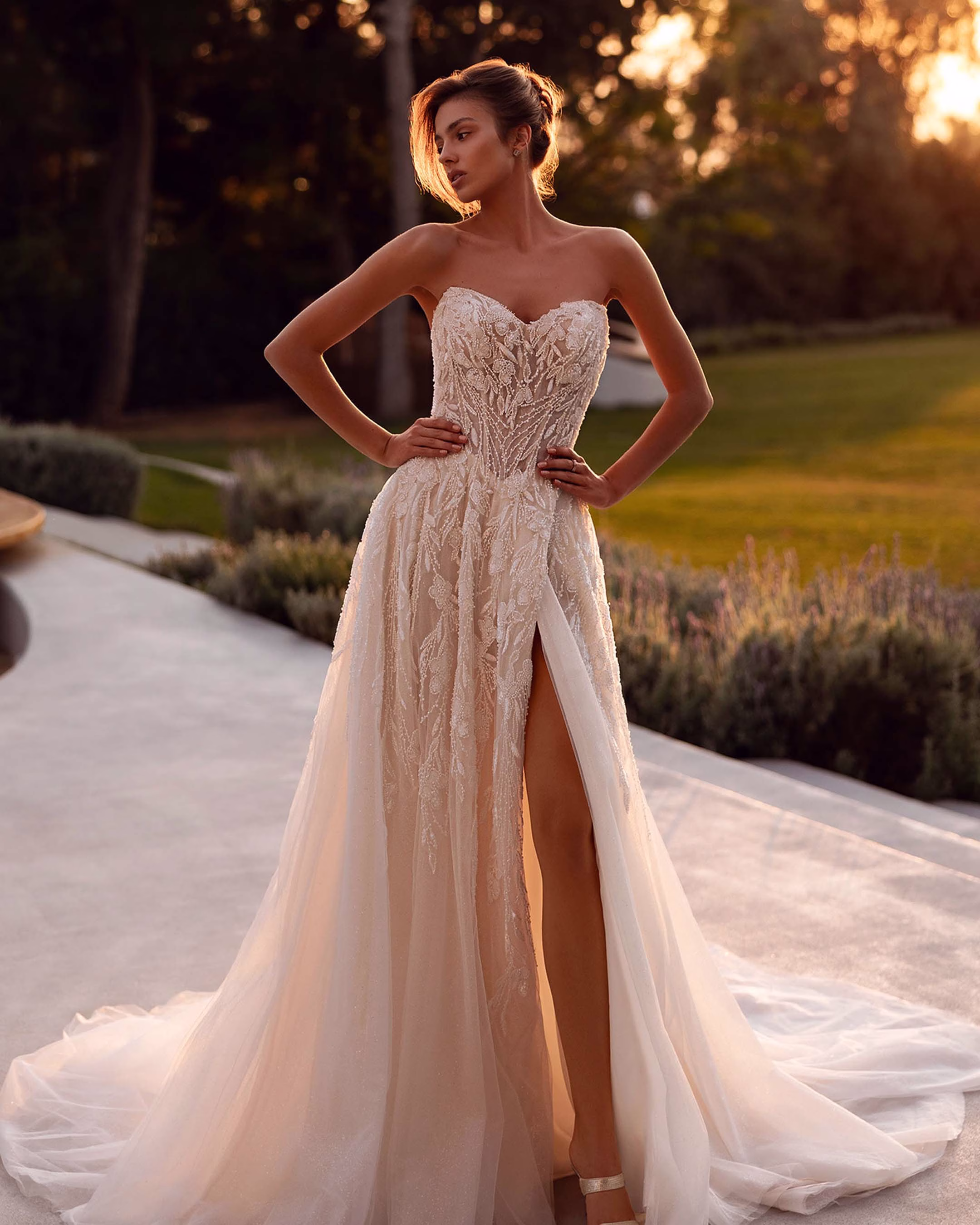 Demetrios Style 1500 beaded lace A-line wedding dress with a strapless sweetheart neckline, sparkling tulle, structured bodice, high slit, and elegant train.