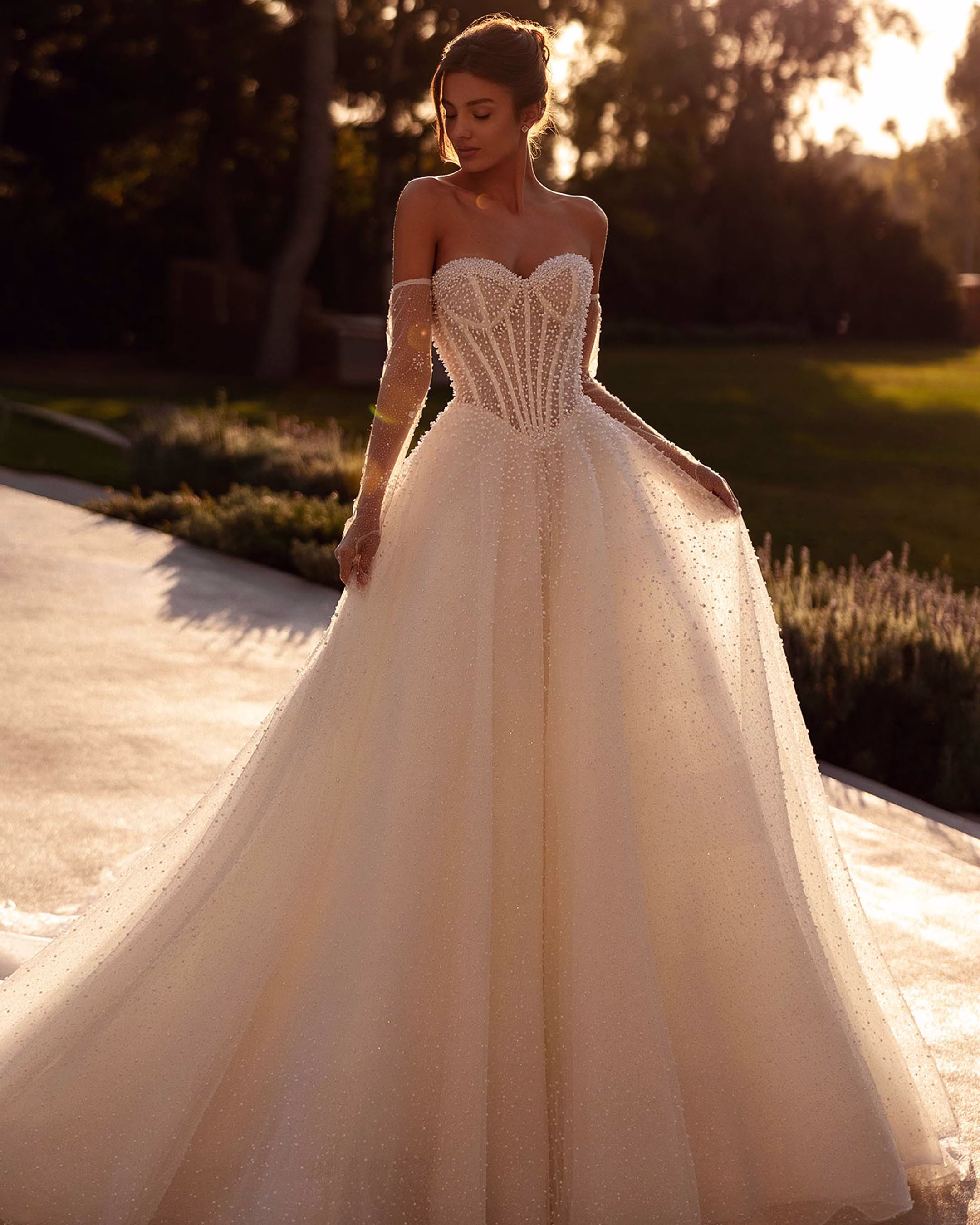 Demetrios Style 1505 A-line wedding dress with a pearl-accented corset bodice, layered tulle skirt, romantic silhouette, and elegant train.