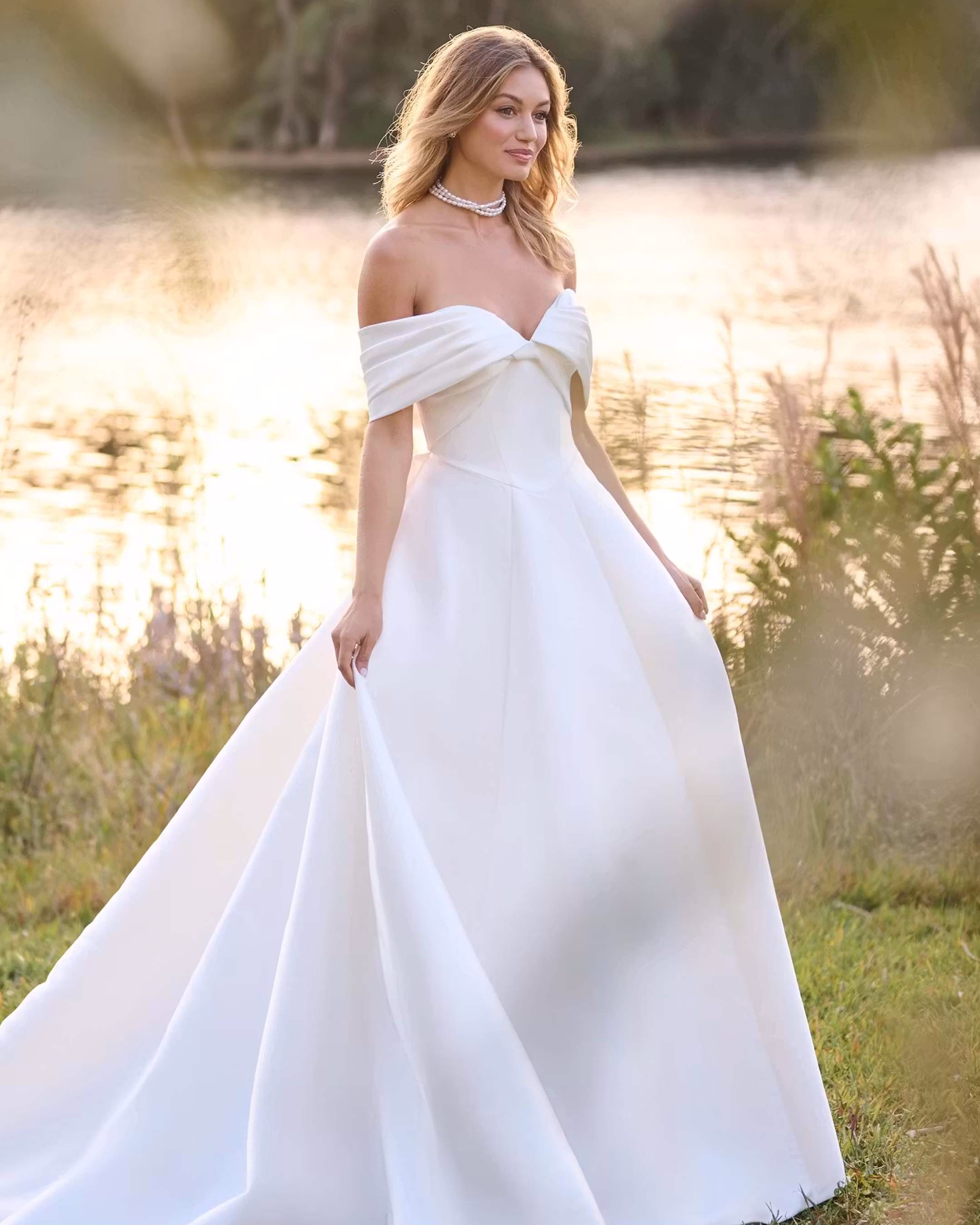 Rebecca Ingram Brooke A-line wedding dress featuring a strapless sweetheart neckline, draped Mikado bodice, illusion back, pockets, and elegant bridal details.