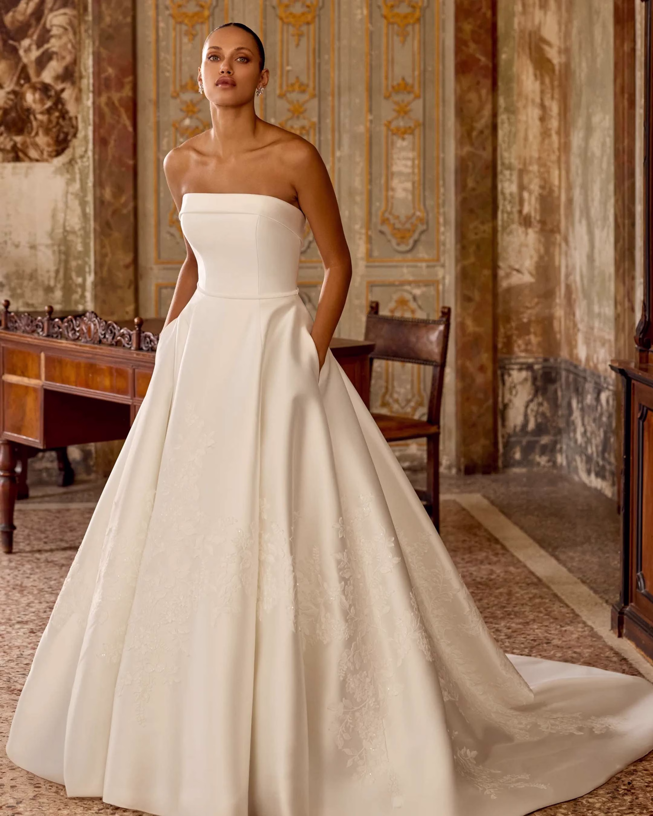 Justin Alexander Kaydence A-line wedding dress featuring a structured bodice, flowing skirt, romantic silhouette, and elegant train.