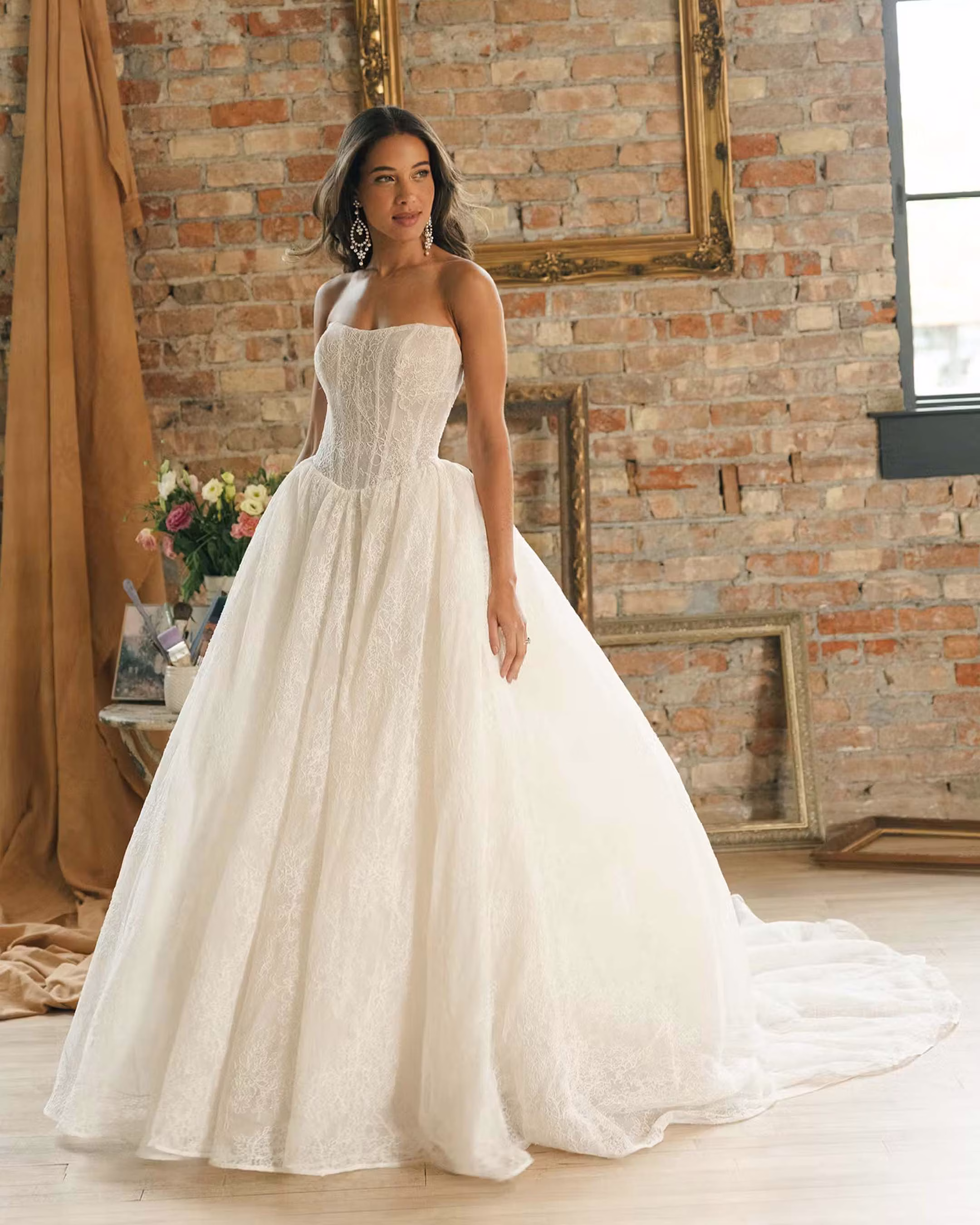 Maggie Sottero Raquel fit-and-flare wedding dress featuring elegant lace details, a figure-flattering silhouette, romantic bridal style, and graceful train.