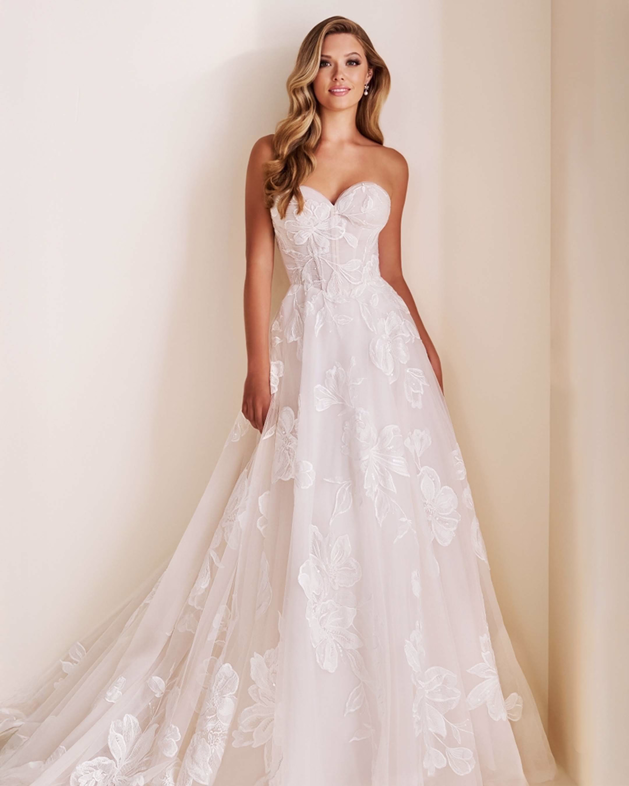Enchanting by Mon Cheri E603 A-line wedding dress featuring Schiffli lace appliqué, sequin details, sweetheart neckline, tulle skirt, and 78-inch train.