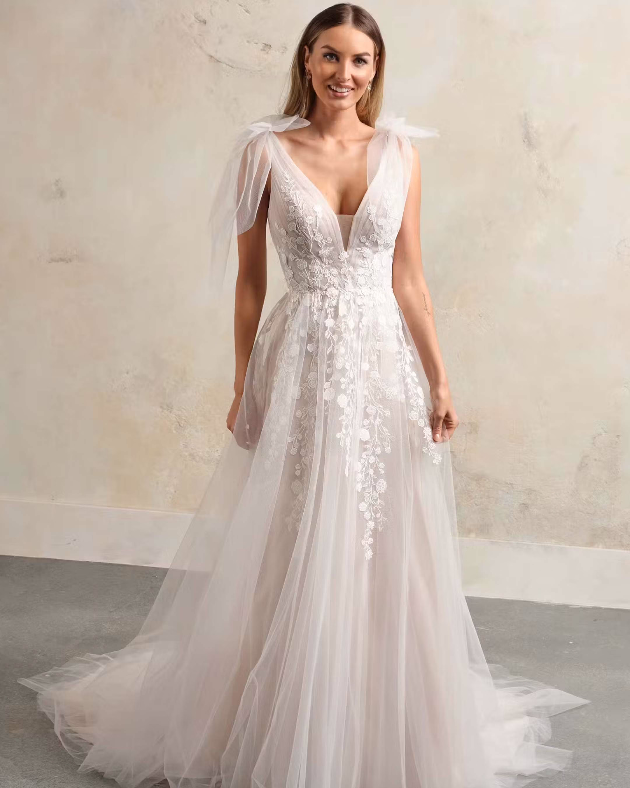 Rebecca Ingram Zinnia A-line wedding dress featuring romantic details, a flattering silhouette, flowing skirt, and elegant bridal train.