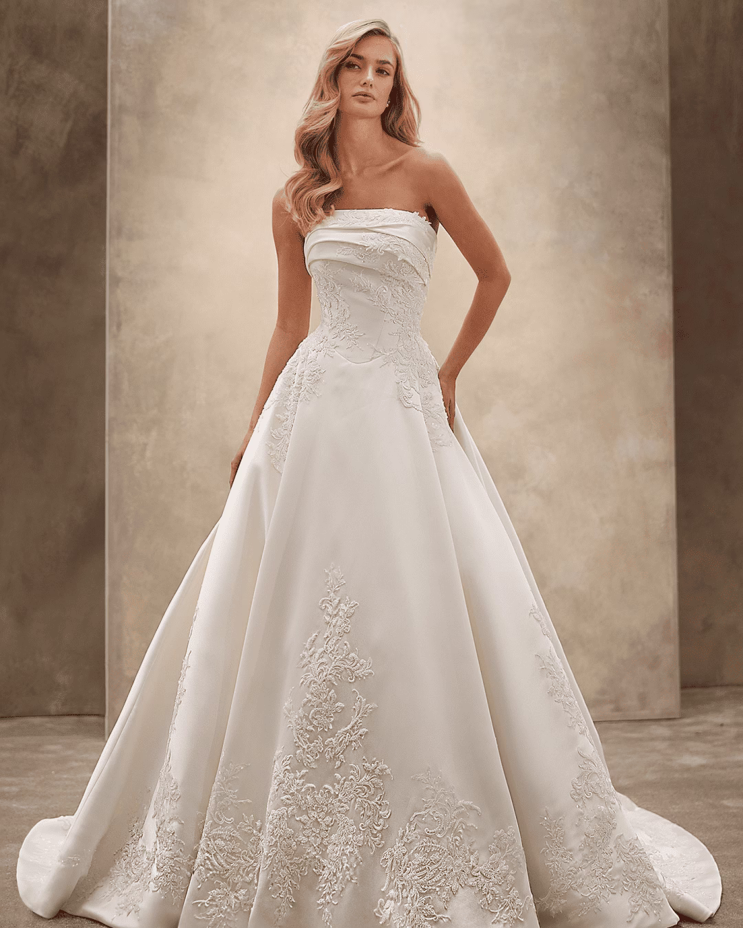 Demetrios Style 1529 A-line wedding dress with a strapless ruched neckline, structured bodice, pleated Mikado skirt, lace accents, and flowing train.