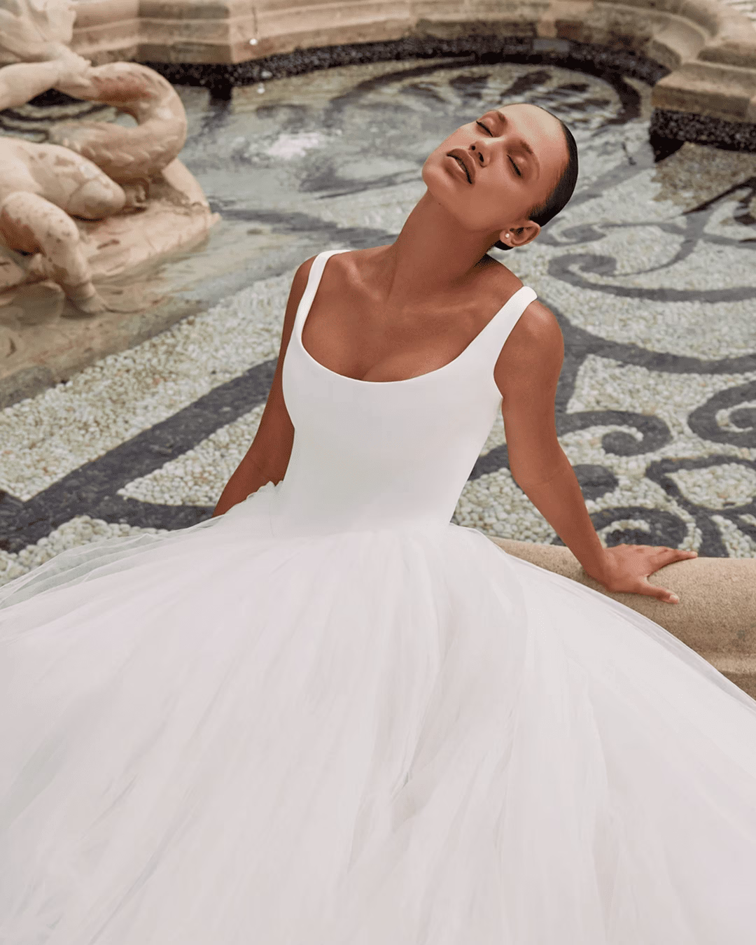 Justin Alexander Kingston fit-and-flare wedding dress featuring a structured bodice, sleek silhouette, elegant train, and modern bridal design.