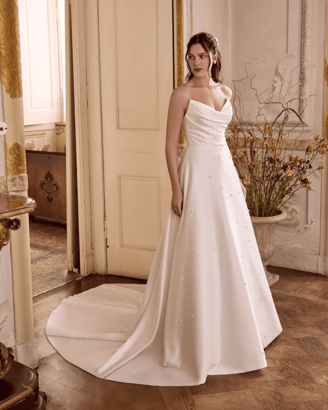 Justin Alexander Lizzie A-line wedding dress featuring a romantic lace bodice, flowing skirt, elegant silhouette, and graceful train.
