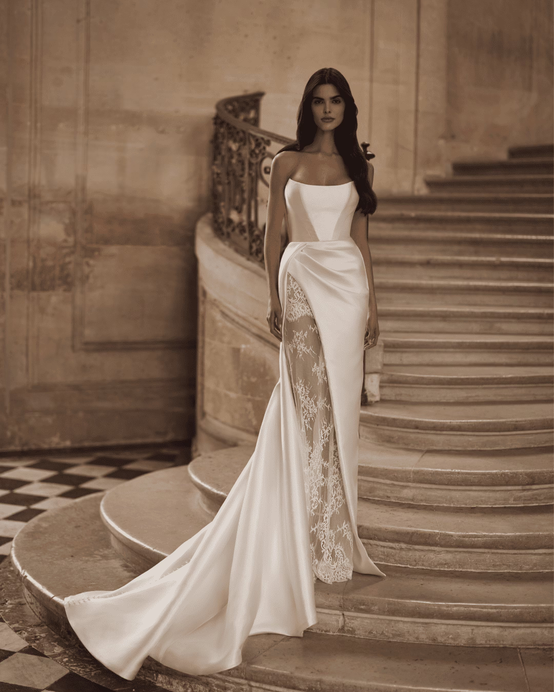 Milla Nova Aldrans satin ball gown wedding dress with a structured corset bodice, strapless neckline, full skirt, and dramatic train.