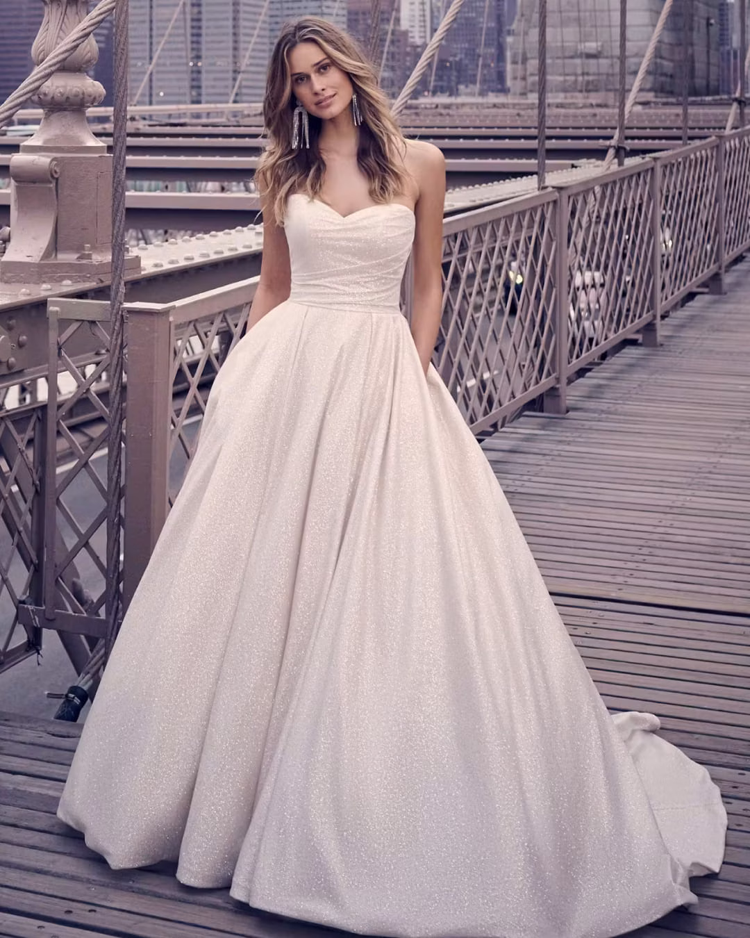 Maggie Sottero Anniston A-line wedding dress featuring romantic lace details, a flattering silhouette, flowing skirt, and elegant bridal train.