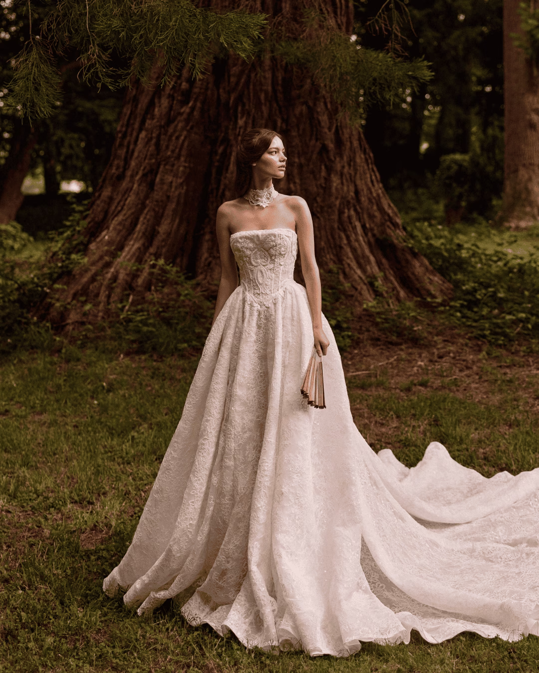 Milla Nova Qirelle lace mermaid wedding dress with a structured corset bodice, delicate lace detailing, fitted silhouette, and elegant train.