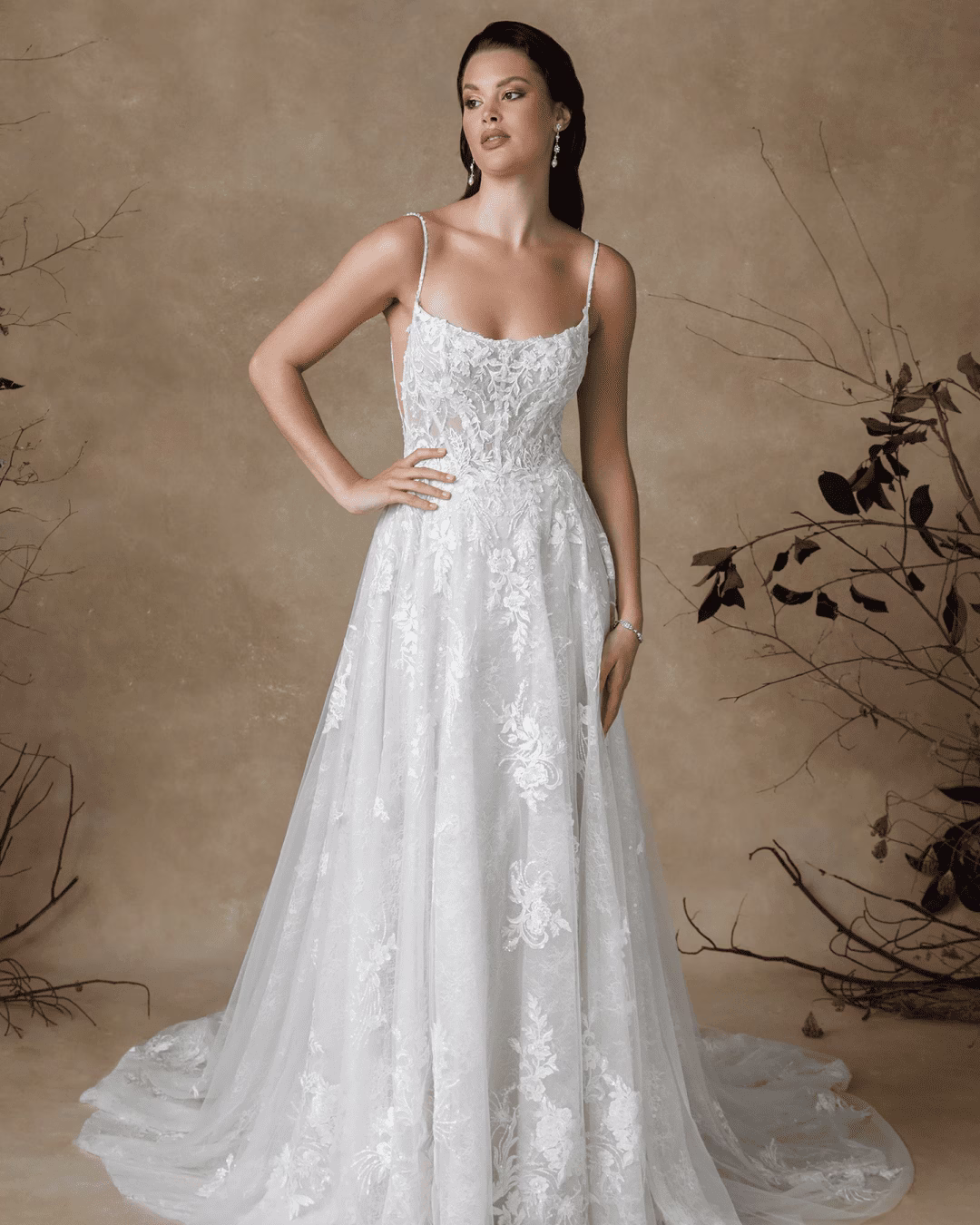 Justin Alexander Glenda fit-and-flare wedding dress featuring an intricately detailed lace bodice, flattering silhouette, elegant train, and romantic bridal style.